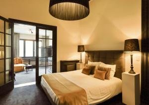 a bedroom with a large bed and a living room at B in Antwerp in Antwerp