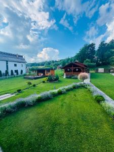 a garden with a pavilion and a building at Pensiunea Edia in Borşa +17 photos
