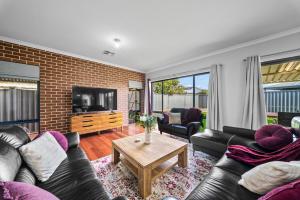 a living room with a couch and a tv at Nest in The Vines in The Vines