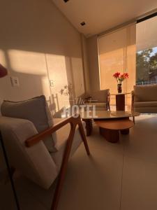 a living room with a couch and a table and chairs at The Hotel in Teresina