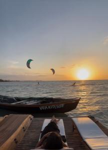 two people on a boat on the water with kites at Yara Floating Villa in Guriú