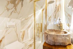 a bathroom with a marble sink and a shower at Tatra Forest Apartments in Zakopane +236 photos