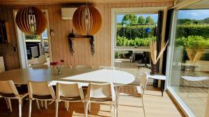 a dining room with a white table and chairs at Holiday Home Als - Starfish in Nordborg