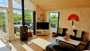 a living room with a couch and a tv at Holiday Home Als - Starfish in Nordborg
