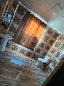 a bathroom with a sink and a toilet at Cozy-home in Kobuleti