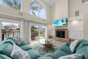 a living room with a blue couch and a fireplace at Salt Life Sanctuary in Sanibel