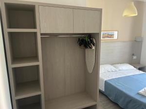 a bedroom with a book shelf and a bed at Residence Abamar in Rimini