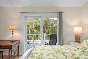 a bedroom with a bed and a sliding glass door at Salt Life Sanctuary in Sanibel +105 photos