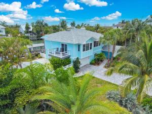 an aerial view of a blue house with palm trees at Salt Life Sanctuary in Sanibel