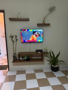 a television on a wall in a living room at Studio Paisible Aéroport FHB in Abidjan