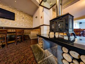 a fireplace in a room with a bar and a restaurant at Cockerham Sands Holiday Park in Cockerham