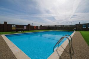 a large blue swimming pool on top of a building at Cockerham Sands Holiday Park in Cockerham