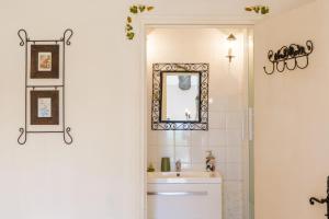 a bathroom with a sink and a mirror at Chez Bacchus - Chambres in Gras