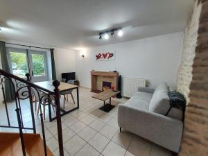a living room with a couch and a fireplace at Le Liboureau in Saint-Jean-de-Vaux