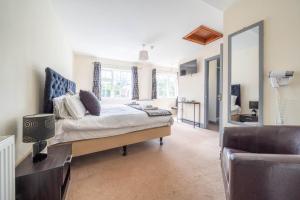 a bedroom with a bed and a large mirror at Kings Arms Hotel in Cleobury Mortimer