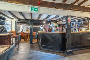 a bar in a restaurant with a sign above it at Kings Arms Hotel in Cleobury Mortimer