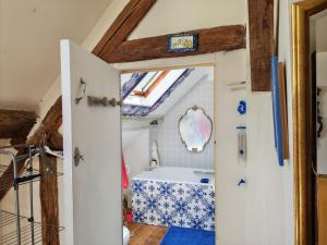 a bathroom with a bath tub in a house at Une chambre en Amazonie in Le Menoux