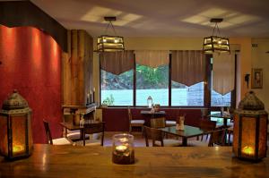 a restaurant with tables and chairs and a large window at Xenonas Sta Tzakia in Karpenisi