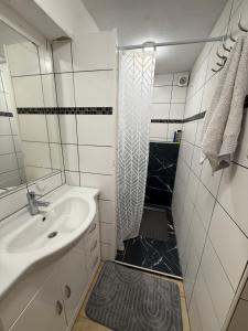 a white bathroom with a shower and a sink at Apartament bei Oberndorf in Oberndorf bei Schwanenstadt