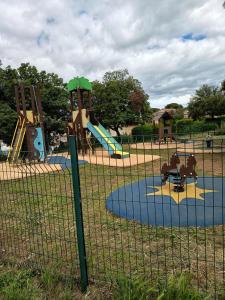 a park with a playground with a slide at La Garrigue in Calvisson