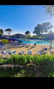 a pool with chairs and a water park at La Garrigue in Calvisson