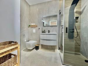 a bathroom with a shower and a toilet and a sink at Marina Seaside Escape in Malinska