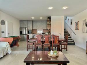 a living room with a table and chairs and a kitchen at Marina Seaside Escape in Malinska