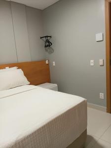 a bedroom with a large white bed in a room at The Hotel in Teresina