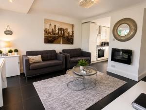 a living room with a couch and a table at 18 river view chalet-Glan Gwna Holiday Park in Caernarfon