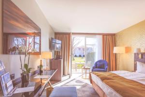 a hotel room with a bed and a balcony at SCHLOSS Fleesensee in Göhren-Lebbin +99 photos