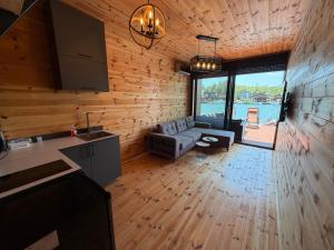 a kitchen and living room with a couch and a table at NiL Cottage in Ulcinj