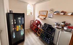 a room with a refrigerator filled with lots of bottles at Ferienhof-Wohler-Wohnung-4 in Bojendorf