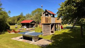 a play structure with a ping pong table in a yard at Ferienhof-Wohler-Wohnung-4 in Bojendorf