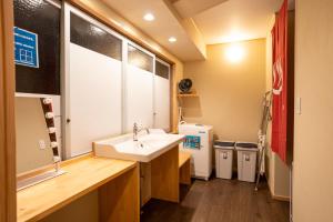 a bathroom with a sink and two trash cans at 尾道つばめ堂 Onomichi Tsubamedo in Onomichi +96 photos