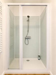 a shower with a glass door in a bathroom at Studio cosy avec terrasse - Proche château in Fougères