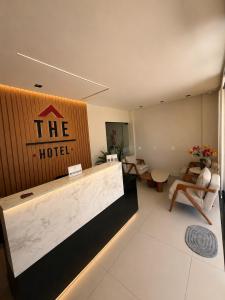 a hotel lobby with a hotel sign on the wall at The Hotel in Teresina