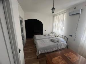 a bedroom with two beds and a table in it at Tonir House in Goris