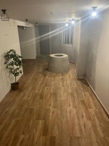 a room with a table on a wooden floor at Tonir House in Goris