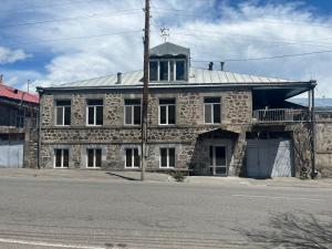 an old stone building with a tower on top of it at Tonir House in Goris