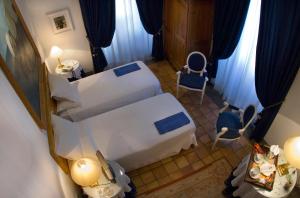 
a hotel room with two beds and a television at Hotel Locanda Cairoli in Rome
