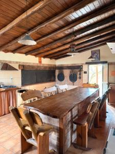 a kitchen with a large wooden table and chairs at Cabaña de campo in Tanti