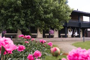 a building with pink flowers in front of it at Toosikannu Nature Resort & Hotel in Käru
