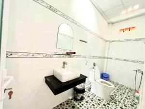 a bathroom with a sink and a toilet at VitaSea Mui Ne homestay & pool in Mui Ne +40 photos