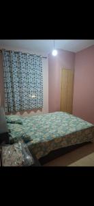 a bedroom with a bed and a window with a curtain at شقق للكراء في سلوان in Selouane
