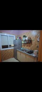 a kitchen with a refrigerator and a counter top at شقق للكراء في سلوان in Selouane