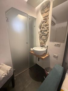 a bathroom with a sink and a shower at Alley House in Cefalù +36 photos