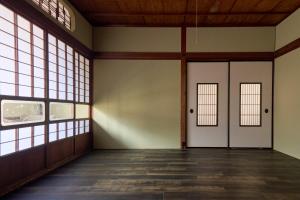 an empty room with doors and windows at Kanazawa Machiya Kasaichi - Entire House Free Parking in Kanazawa