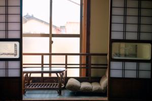 a room with a table and a large window at Kanazawa Machiya Kasaichi - Entire House Free Parking in Kanazawa