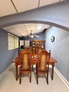 a dining room with a wooden table and chairs at La Casona Guest House in La Unión