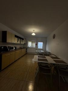 an empty kitchen with tables and chairs in a room at Vila Adelin in Tăşnad +5 photos